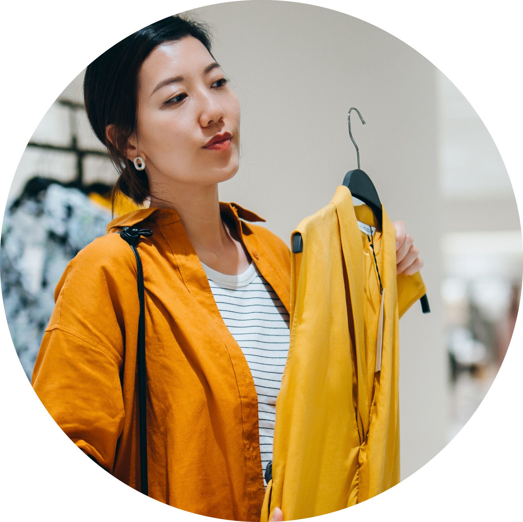 woman holding up yellow dress