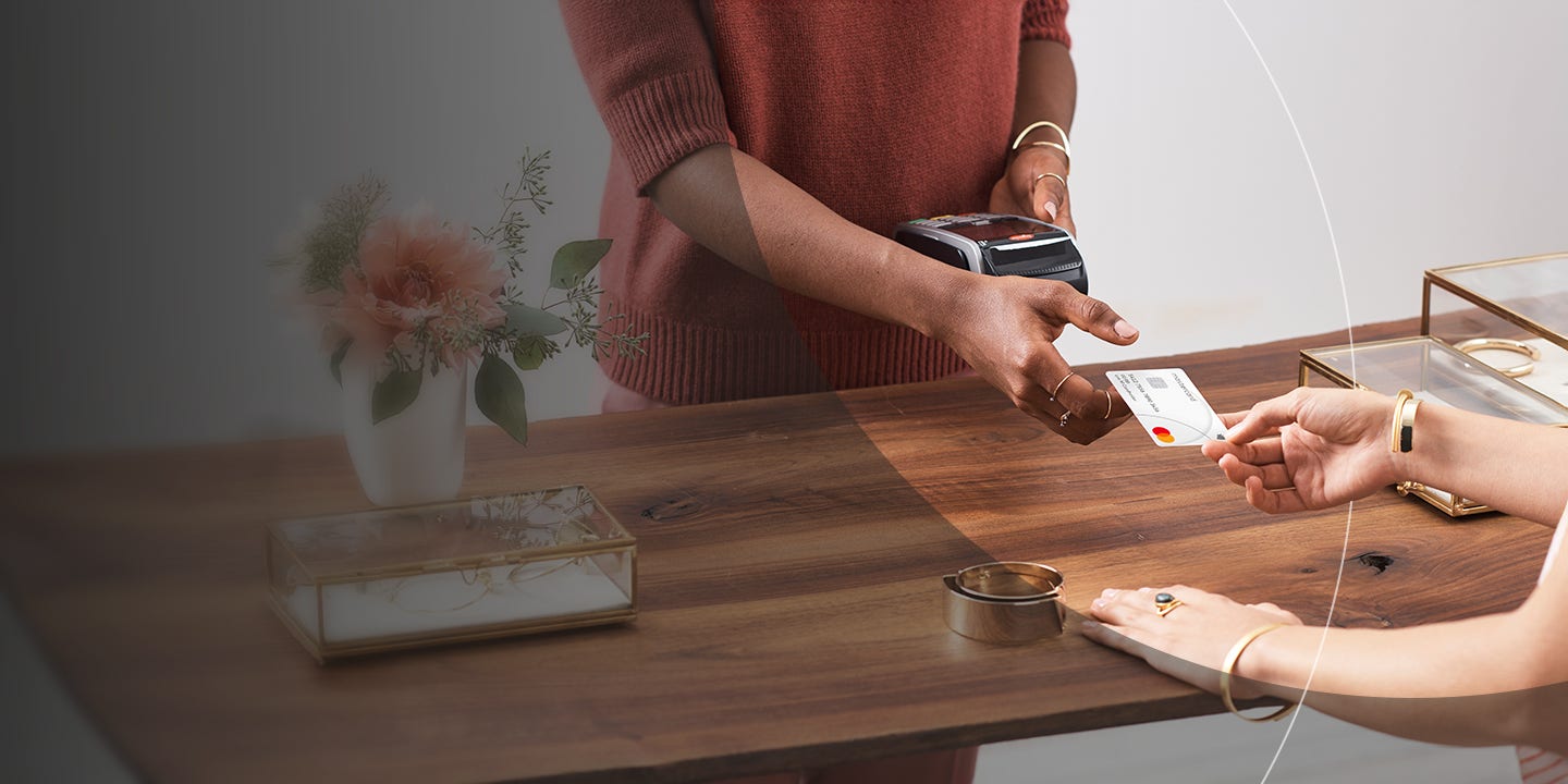 Woman paying at shop with card.
