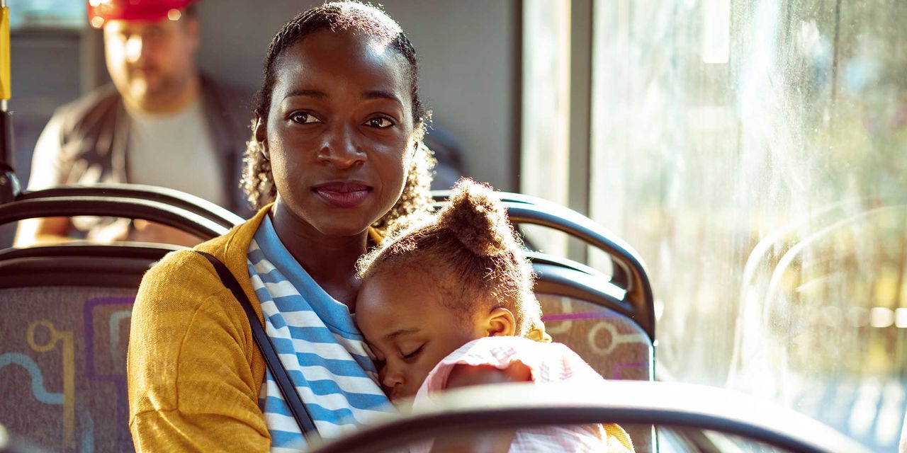Woman and daughter riding on public transportation