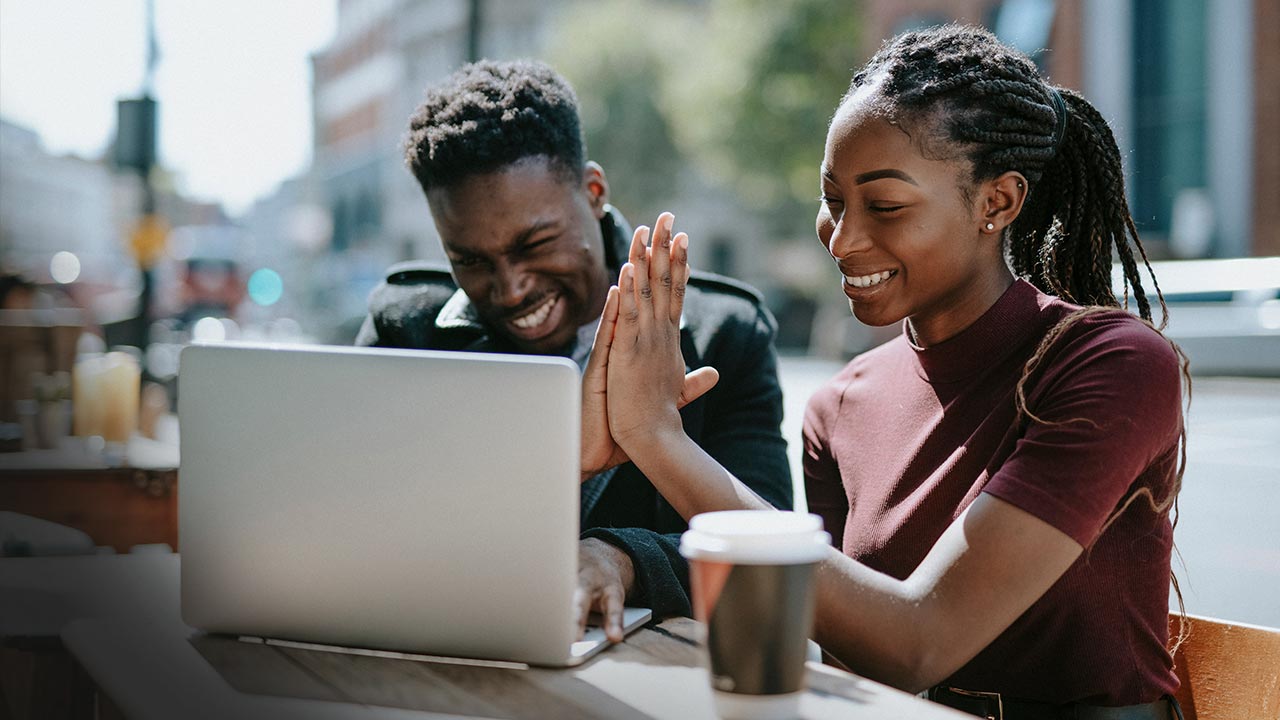Young people giving each other a high five.