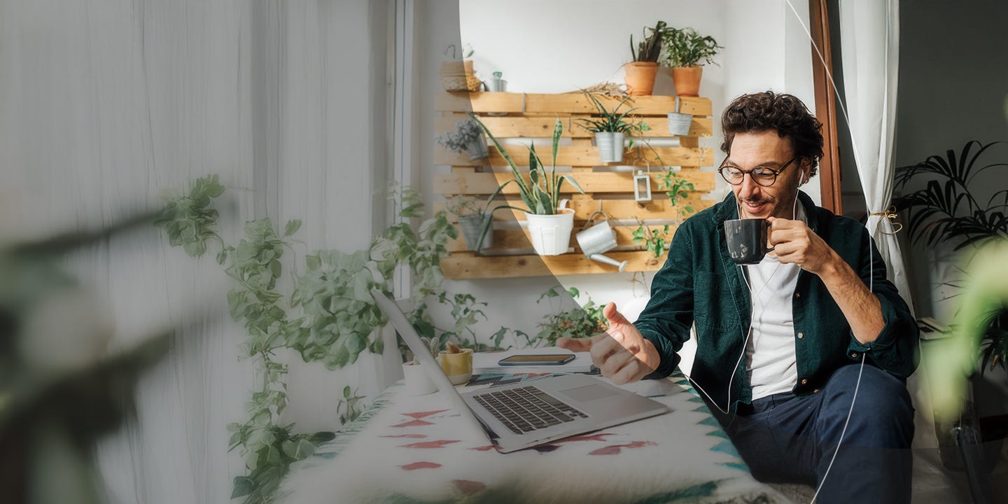 Man with laptop sipping coffee.