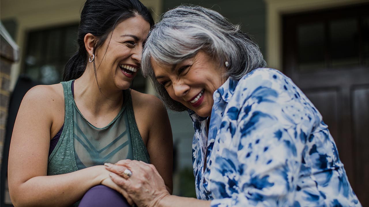 Two women laughing together.