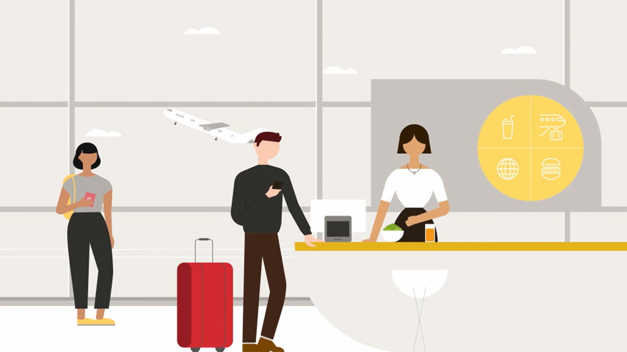 A group of people standing at an airport counter, checking in for their flights.