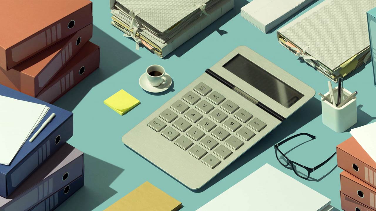 Calculator and binders on table.