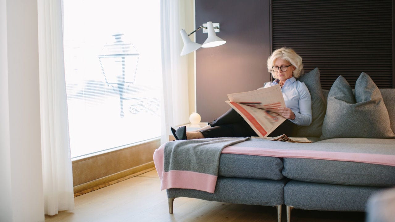 Business woman reading newspaper.