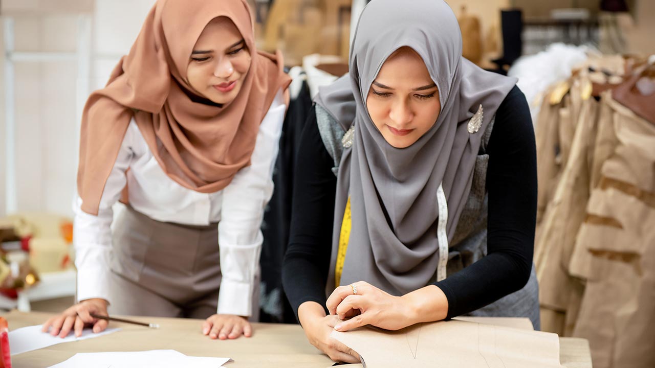 Woman in hijab, working in an atelier.