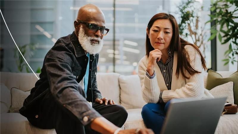 Man and women looking at laptop