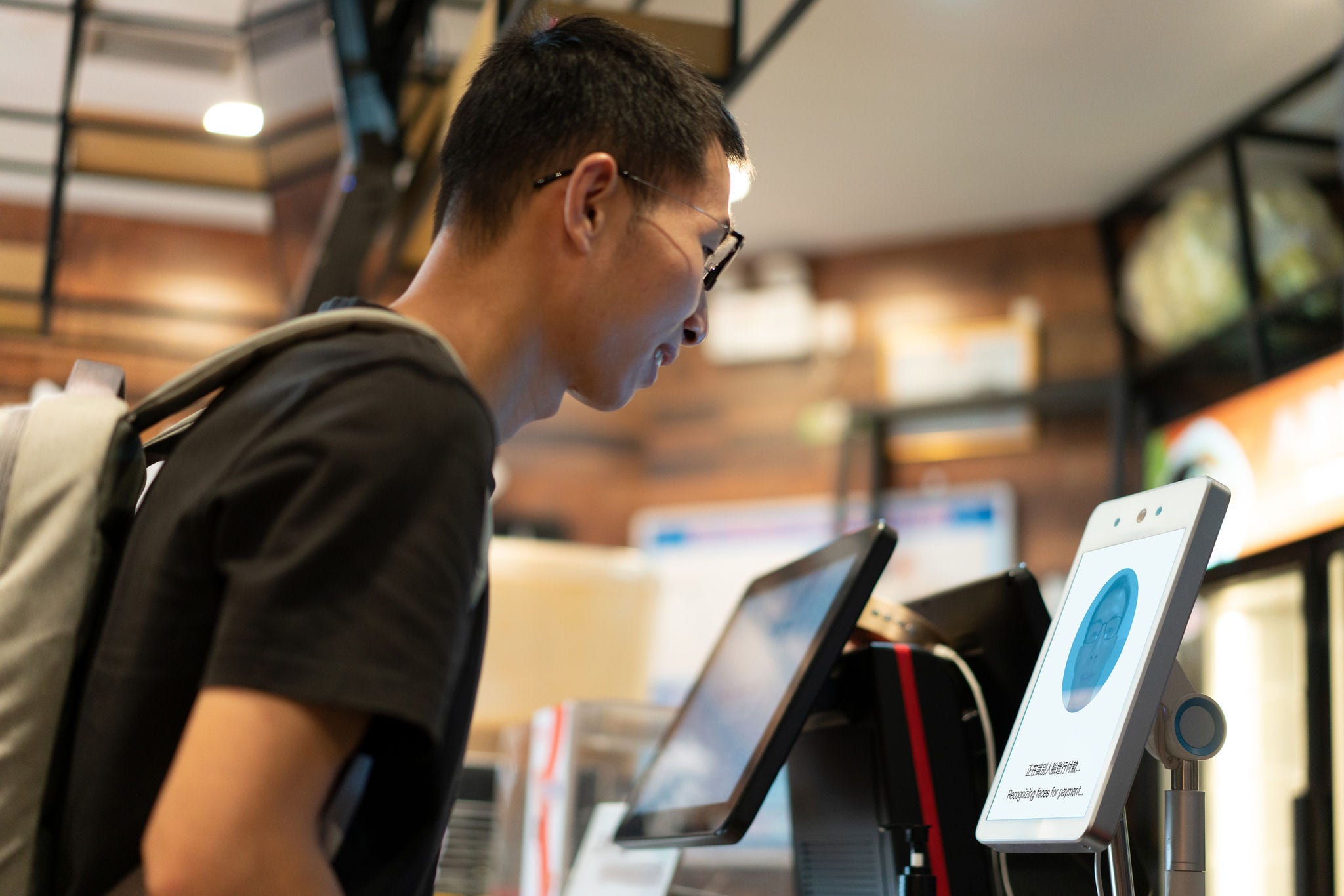 man looking at facial recognition screen
