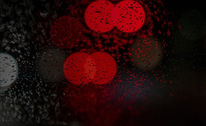 A blurred red lights through the glass window.