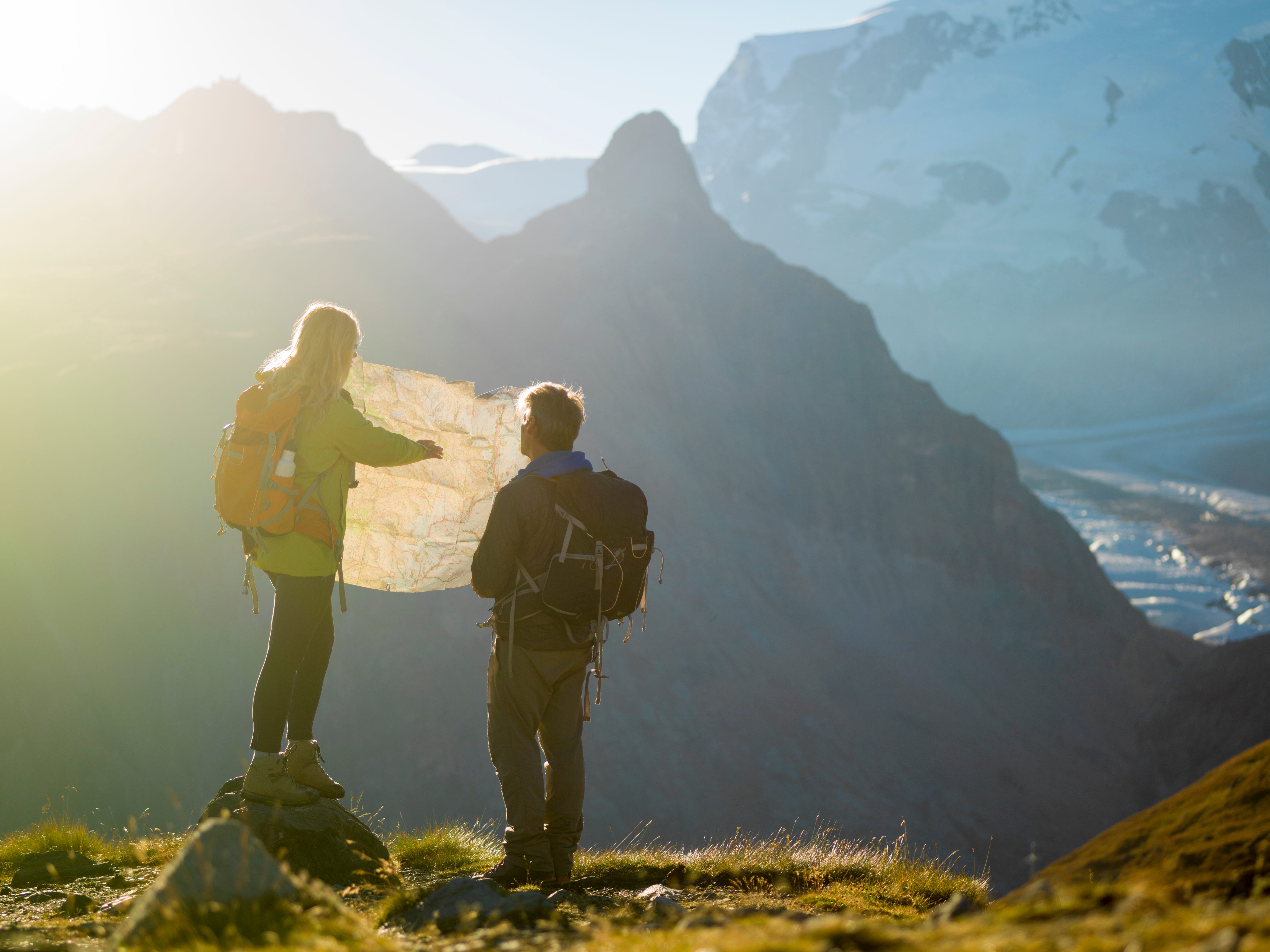 Two mountain climbers looking at a map.