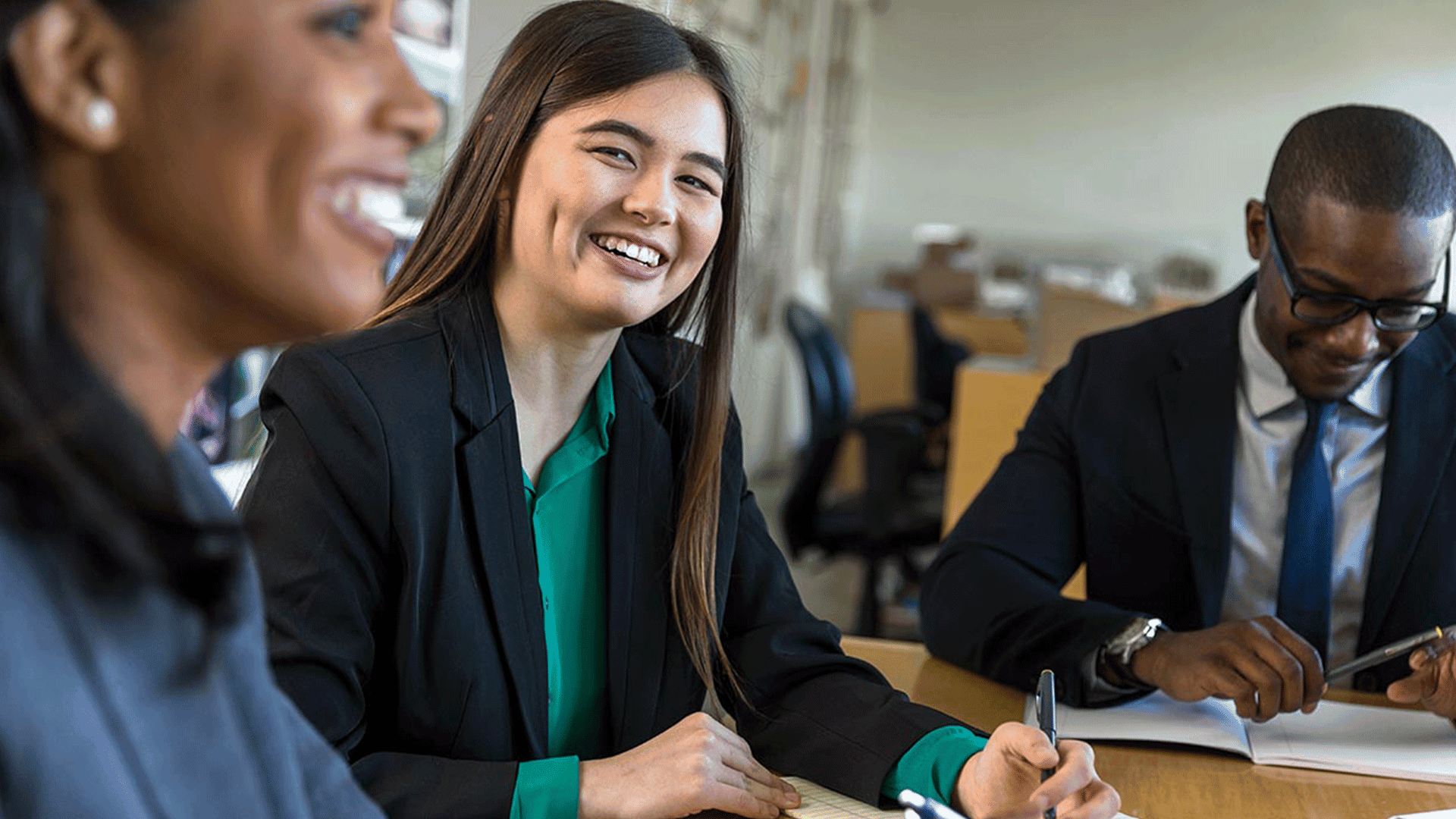 Smiling businesswoman working with her colleagues.