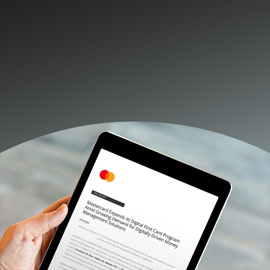a man holding an ipad reading digital first program expansion article.