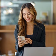 young asian businesswoman using phone at office.
