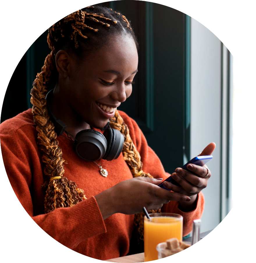 woman smiling at phone after successful transaction