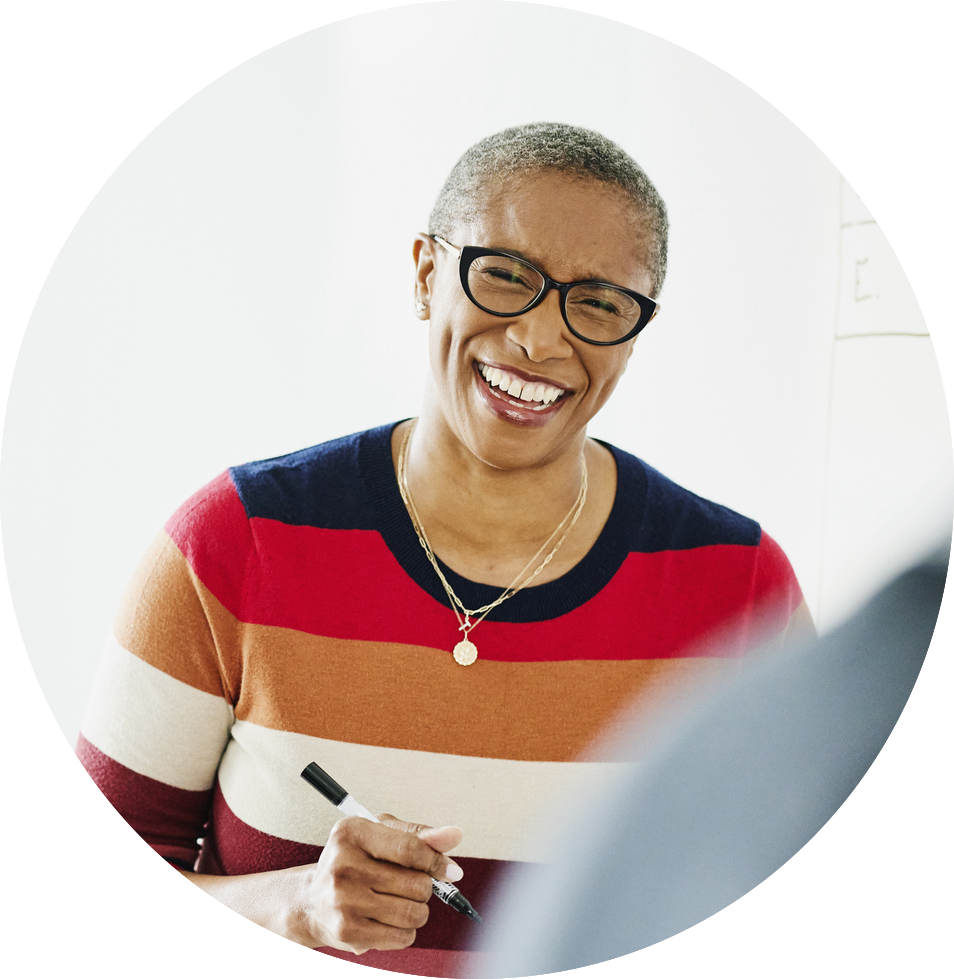 woman smiling with pen and paper